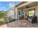 Relaxing covered patio features brick flooring, outdoor seating, TV, and a screened-in area at 17640 Northwood Pl, Bradenton, FL 34202