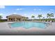 Inviting outdoor pool area with lounge chairs, shaded pavilion, and lush landscaping for a relaxing experience at 17640 Northwood Pl, Bradenton, FL 34202
