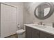 Well-lit bathroom offers a sleek vanity, modern fixtures, decorative mirror, and a double door linen closet at 1951 San Silvestro Dr, Venice, FL 34285