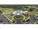 Aerial view of community clubhouse, golf course, lake and lush landscaping at 1951 San Silvestro Dr, Venice, FL 34285