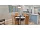 Cozy dining area with a round table, seating for four, and kitchen view at 1951 San Silvestro Dr, Venice, FL 34285