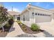 Charming home exterior with well-manicured landscaping, tile roof, and attached garage at 1951 San Silvestro Dr, Venice, FL 34285