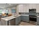 Modern kitchen featuring stainless steel appliances, stone countertops and backsplash at 1951 San Silvestro Dr, Venice, FL 34285