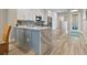 Bright, modern kitchen with white cabinets, stainless steel appliances, and a large island at 1951 San Silvestro Dr, Venice, FL 34285