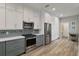 Modern kitchen with stainless steel appliances, ample cabinet space, and stylish backsplash at 1951 San Silvestro Dr, Venice, FL 34285