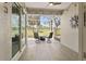 Relaxing screened-in lanai with a cozy fire pit, comfortable seating, and beautiful golf course views at 1951 San Silvestro Dr, Venice, FL 34285