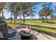 Inviting outdoor lanai boasts a fire pit, comfortable seating, golf course views, and screened enclosure at 1951 San Silvestro Dr, Venice, FL 34285