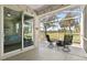 This inviting lanai offers outdoor relaxation with comfortable seating, fire pit, and views of golf course at 1951 San Silvestro Dr, Venice, FL 34285