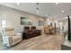 Open floor plan living room with seating, a ceiling fan, and views into the kitchen and dining area at 1951 San Silvestro Dr, Venice, FL 34285