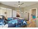 Main bedroom with neutral paint, wood-look floors, and access to the en suite and the rear lanai at 1951 San Silvestro Dr, Venice, FL 34285