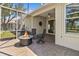Relaxing screened-in patio featuring a cozy fire pit and comfortable seating for outdoor enjoyment at 1951 San Silvestro Dr, Venice, FL 34285