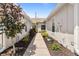 Exterior walkway with lush landscaping on both sides of the home at 1951 San Silvestro Dr, Venice, FL 34285