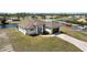 Waterfront property featuring a modern home, a brown roof, and paved driveway near intersecting roads at 197 Rotonda Cir, Rotonda West, FL 33947