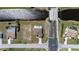 Home with private pool, brown roof, and paved driveway sits near a road with a canal nearby at 197 Rotonda Cir, Rotonda West, FL 33947