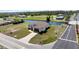 Modern waterfront home, featuring a brown roof and paved driveway near intersecting roads at 197 Rotonda Cir, Rotonda West, FL 33947