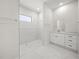 Modern bathroom with glass enclosed shower, marble tile, and white cabinets offer a spa-like experience at 197 Rotonda Cir, Rotonda West, FL 33947