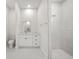 Modern bathroom with a glass shower, white cabinets, marble floors and walls, and contemporary fixtures at 197 Rotonda Cir, Rotonda West, FL 33947