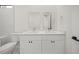 Clean bathroom with double vanity and quartz countertops in this modern home at 197 Rotonda Cir, Rotonda West, FL 33947