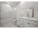 Elegant bathroom with double vanity, soaking tub, and bright, natural light at 197 Rotonda Cir, Rotonda West, FL 33947