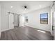 Sunlit bedroom features modern sliding doors, wood floors, and two windows for ample natural light at 197 Rotonda Cir, Rotonda West, FL 33947