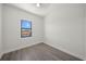 Bright bedroom with wood-look flooring and a window offering scenic views at 197 Rotonda Cir, Rotonda West, FL 33947