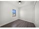 Cozy bedroom featuring wood-look floors and a window with neighborhood views at 197 Rotonda Cir, Rotonda West, FL 33947