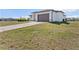 Beautiful shot of a home's front lawn with a paver driveway leading up to a two car garage at 197 Rotonda Cir, Rotonda West, FL 33947