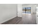 Bright living room features sliding glass doors that open to the pool deck and modern, wood-look floors at 197 Rotonda Cir, Rotonda West, FL 33947