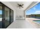 Spacious covered patio with outdoor kitchen, ceiling fan, and waterfront views at 197 Rotonda Cir, Rotonda West, FL 33947