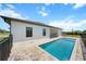 Back of house shows the in-ground pool, patio, and outdoor grill at 197 Rotonda Cir, Rotonda West, FL 33947