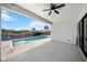 Covered patio with ceiling fan overlooks a beautiful in-ground pool and waterfront view at 197 Rotonda Cir, Rotonda West, FL 33947