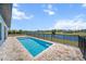 In-ground pool has a waterfront view that is fenced in for safety at 197 Rotonda Cir, Rotonda West, FL 33947