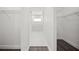 Bright walk-in closet with white wire shelving leading to a bright and clean en-suite bathroom at 197 Rotonda Cir, Rotonda West, FL 33947