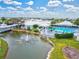 Aerial view of the community center including a pond, a fountain, a pool, and a clubhouse at 22324 Wexford Blvd, Venice, FL 34293
