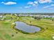 Scenic aerial view of a golf course community featuring multiple ponds and well-manicured greens at 22324 Wexford Blvd, Venice, FL 34293