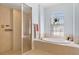Elegant bathroom featuring a soaking tub, walk-in shower with tile surround, and natural light at 22324 Wexford Blvd, Venice, FL 34293