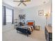 Comfortable bedroom with neutral carpet, a ceiling fan, and a colorful bed spread at 22324 Wexford Blvd, Venice, FL 34293