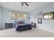 Bright bedroom with neutral carpet, a ceiling fan, and a large window at 22324 Wexford Blvd, Venice, FL 34293