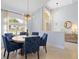 Dining area with stylish light fixture and bright windows overlooking the outdoors at 22324 Wexford Blvd, Venice, FL 34293