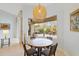 Bright dining area with a round table, view to lanai, and a unique woven pendant light fixture at 22324 Wexford Blvd, Venice, FL 34293