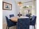 Cozy dining area with a stylish chandelier and large window bringing in natural light at 22324 Wexford Blvd, Venice, FL 34293