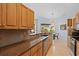 Kitchen with granite countertops, stainless steel appliances, and wood cabinets at 22324 Wexford Blvd, Venice, FL 34293