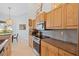 Kitchen featuring granite countertops, stainless steel appliances, and wood cabinets at 22324 Wexford Blvd, Venice, FL 34293