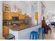 Kitchen featuring a breakfast bar, stainless steel appliances, and wood cabinetry at 22324 Wexford Blvd, Venice, FL 34293