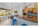 Kitchen with granite countertops, stainless appliances, breakfast bar, and adjacent dining area at 22324 Wexford Blvd, Venice, FL 34293