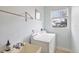 Functional laundry room with washer, dryer, wash basin, and natural light at 22324 Wexford Blvd, Venice, FL 34293