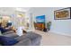 Inviting living room featuring tile floors, comfortable seating, and a decorative entryway at 22324 Wexford Blvd, Venice, FL 34293