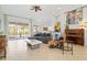 Spacious living room with vaulted ceilings, tile floors, comfortable seating, and natural light from sliding glass doors at 22324 Wexford Blvd, Venice, FL 34293
