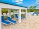 Inviting lounge area with multiple cushioned lounge chairs, under a covered pavilion, perfect for relaxation at 22324 Wexford Blvd, Venice, FL 34293