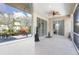 Covered patio featuring tile floors, a ceiling fan, and sliding glass doors at 22324 Wexford Blvd, Venice, FL 34293
